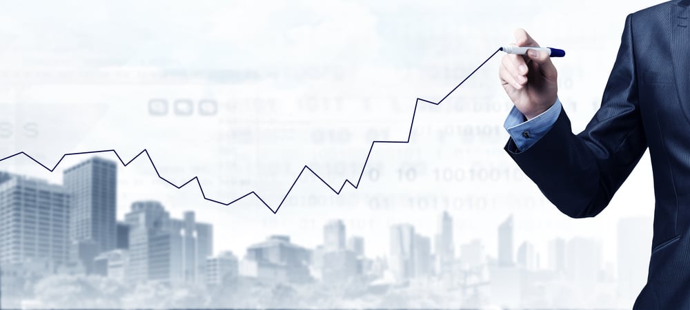 Close up of businessman drawing increasing graph with marker